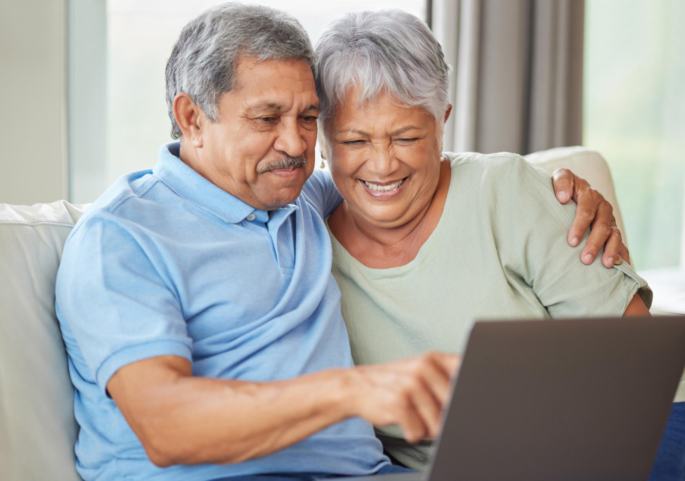 elderly-couple-laptop-video-call-social-media-internet-their-laptop-living-room-sofa-relax-senior-man-woman-watching-reading-news-email-funny-message-online-together-home